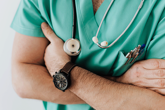 Male nurse with arms folded